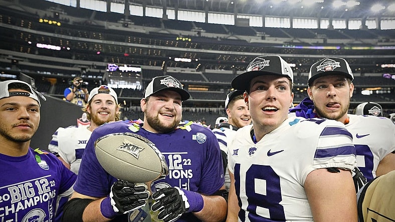 Dec 3, 2022; Arlington, TX, USA; Kansas State Wildcats quarterback Will Howard (18) and his teammates celebrate winning the Big 12 championship after defeating the TCU Horned Frogs in overtime at AT&T Stadium. Mandatory Credit: Jerome Miron-USA TODAY Sports