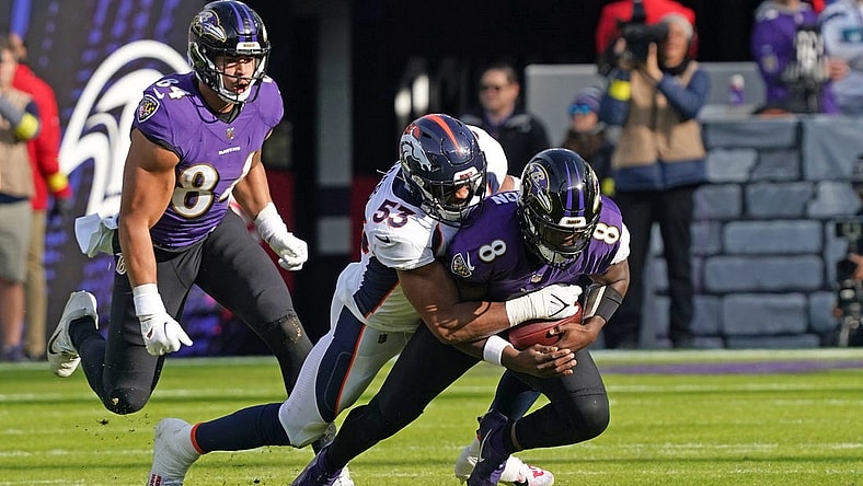 Dec 4, 2022; Baltimore, Maryland, USA; Baltimore Ravens quarterback Lamar Jackson (8) would leave the game after being sacked in the second quarter by Denver Broncos linebacker Jonathon Cooper (53) at M&T Bank Stadium. Mandatory Credit: Mitch Stringer-USA TODAY Sports