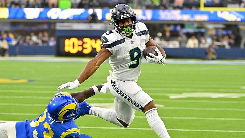 Dec 4, 2022; Inglewood, California, USA; Seattle Seahawks running back Kenneth Walker III (9) runs past Los Angeles Rams safety Nick Scott (33) for a first down in the first half at SoFi Stadium. Mandatory Credit: Jayne Kamin-Oncea-USA TODAY Sports