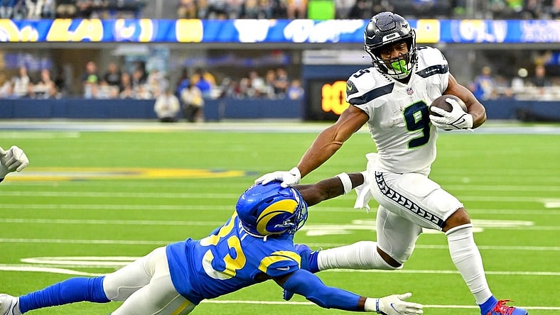 Dec 4, 2022; Inglewood, California, USA; Seattle Seahawks running back Kenneth Walker III (9) runs past Los Angeles Rams safety Nick Scott (33) for a first down in the first half at SoFi Stadium. Mandatory Credit: Jayne Kamin-Oncea-USA TODAY Sports