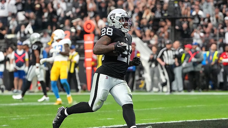 Dec 4, 2022; Paradise, Nevada, USA; Las Vegas Raiders running back Josh Jacobs (28) scores a touchdown against the Los Angeles Chargers during the first half at Allegiant Stadium. Mandatory Credit: Stephen R. Sylvanie-USA TODAY Sports