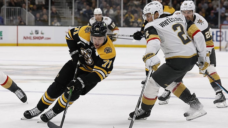 Dec 5, 2022; Boston, Massachusetts, USA; Boston Bruins left wing Taylor Hall (71) goes around Vegas Golden Knights defenseman Zach Whitecloud (2) during the first period at TD Garden. Mandatory Credit: Winslow Townson-USA TODAY Sports