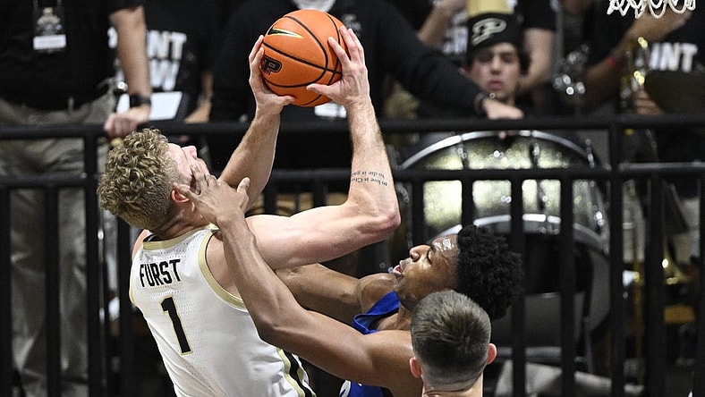 Dec 7, 2022; West Lafayette, Indiana, USA; Hofstra Pride forward Warren Williams (0) gets his hand on the face of Purdue Boilermakers forward Caleb Furst (1) during the first half at Mackey Arena. Mandatory Credit: Marc Lebryk-USA TODAY Sports