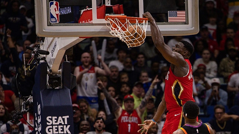 Dec 9, 2022; New Orleans, Louisiana, USA; New Orleans Pelicans forward Zion Williamson (1) dunks the ball against Phoenix Suns guard Devin Booker (1) and forward Torrey Craig (0) during the second half at Smoothie King Center. Mandatory Credit: Stephen Lew-USA TODAY Sports