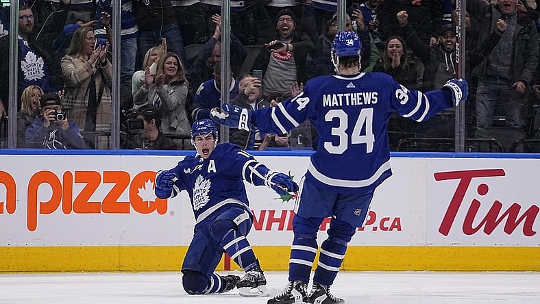 Dec 10, 2022; Toronto, Ontario, CAN; Toronto Maple Leafs forward Mitchell Marner (16) celebrates with forward Auston Matthews (34) after scoring the game winning goal against the Calgary Flames during overtime at Scotiabank Arena. Mandatory Credit: John E. Sokolowski-USA TODAY Sports