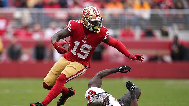Dec 11, 2022; Santa Clara, California, USA; San Francisco 49ers wide receiver Deebo Samuel (19) runs with the ball in front of Tampa Bay Buccaneers linebacker Lavonte David (54) in the second quarter at Levi's Stadium. Mandatory Credit: Cary Edmondson-USA TODAY Sports