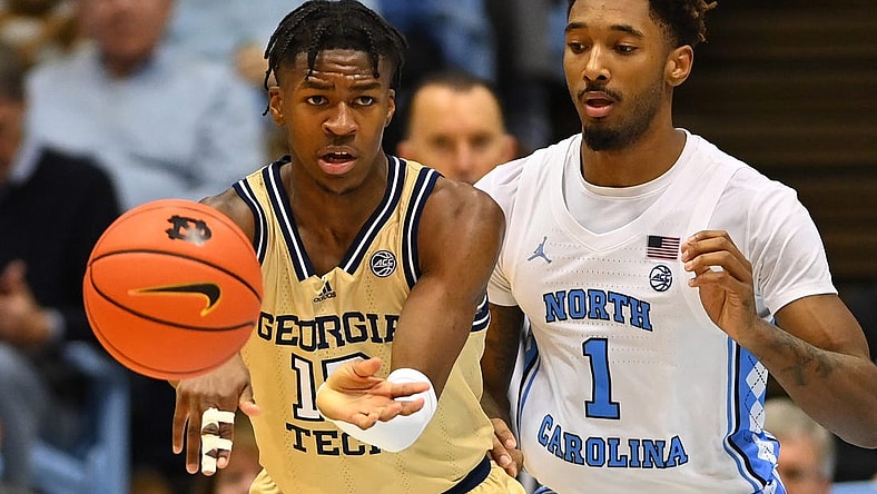 Dec 10, 2022; Chapel Hill, North Carolina, USA; Georgia Tech Yellow Jackets guard Miles Kelly (13) passes the ball as North Carolina Tar Heels forward Leaky Black (1) defends in the second half at Dean E. Smith Center. Mandatory Credit: Bob Donnan-USA TODAY Sports