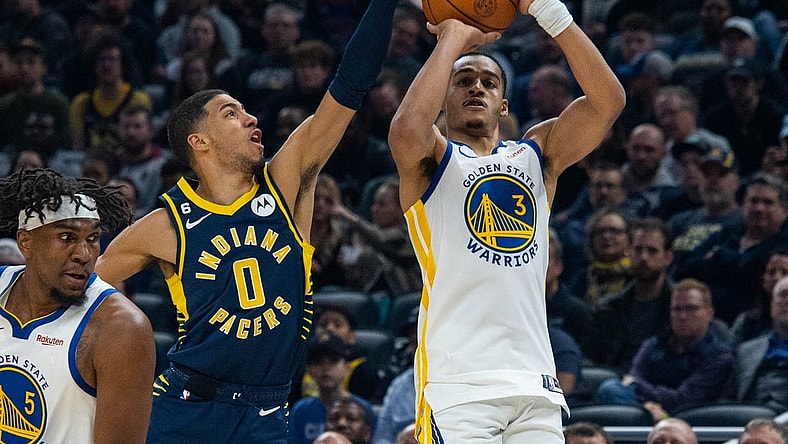 Dec 14, 2022; Indianapolis, Indiana, USA; Indiana Pacers guard Tyrese Haliburton (0) blocks a shot by Golden State Warriors guard Jordan Poole (3) in the first quarter at Gainbridge Fieldhouse. Mandatory Credit: Trevor Ruszkowski-USA TODAY Sports