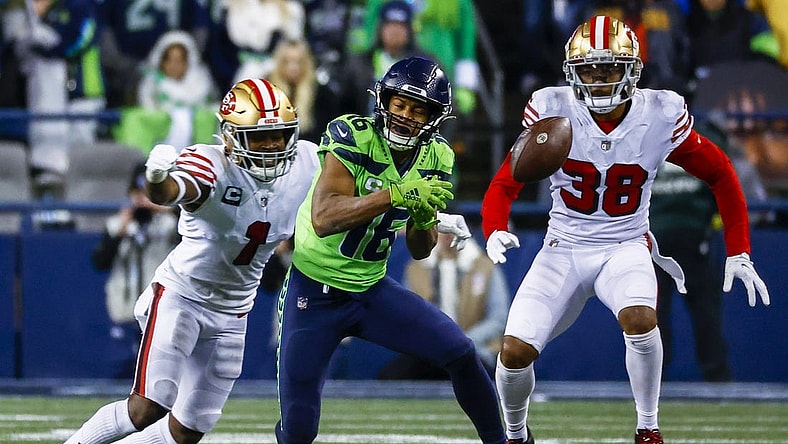 Dec 15, 2022; Seattle, Washington, USA; Seattle Seahawks wide receiver Tyler Lockett (16) drops a pass before being hit by San Francisco 49ers cornerback Jimmie Ward (1) during the fourth quarter at Lumen Field. Mandatory Credit: Joe Nicholson-USA TODAY Sports