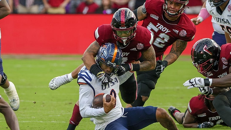 Dec 16, 2022; Orlando, Florida, USA; UTSA Roadrunners quarterback Frank Harris (0) is tackled by Troy Trojans linebacker KJ Robertson (7) during the second quarter at Exploria Stadium. Mandatory Credit: Mike Watters-USA TODAY Sports