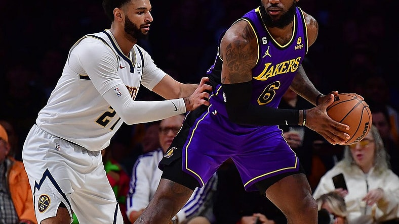 Dec 16, 2022; Los Angeles, California, USA; Los Angeles Lakers forward LeBron James (6) controls the ball against Denver Nuggets guard Jamal Murray (27)  during the first half at Crypto.com Arena. Mandatory Credit: Gary A. Vasquez-USA TODAY Sports