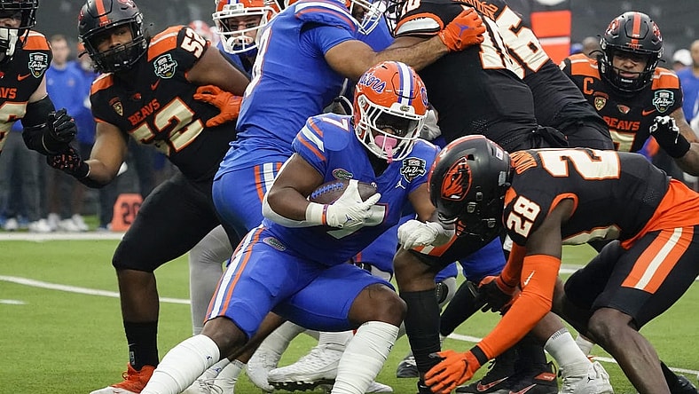 Dec 17, 2022; Las Vegas, NV, USA;  Florida Gators running back Trevor Etienne (7) runs with the ball through the Oregon State Beavers defense during the first half at the Las Vegas Bowl at Allegiant Stadium. Mandatory Credit: Lucas Peltier-USA TODAY Sports
