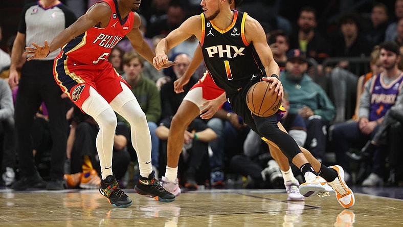 Dec 17, 2022; Phoenix, Arizona, USA; Phoenix Suns guard Devin Booker (1) against New Orleans Pelicans forward Herbert Jones in the first half at Footprint Center. Mandatory Credit: Mark J. Rebilas-USA TODAY Sports