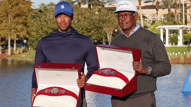 Dec 18, 2022; Orlando, Florida, USA; Vijay Singh (right) and Qass Singh hold up the Champions trophy after winning the PNC Championship golf tournament at Ritz Carlton Golf Club Grande Lakes Orlando Course. Mandatory Credit: Reinhold Matay-USA TODAY Sports