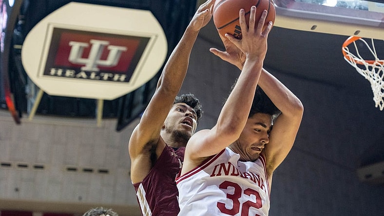 Dec 20, 2022; Bloomington, Indiana, USA; Indiana Hoosiers guard Trey Galloway (32) rebounds the ball while Elon Phoenix guard Max Mackinnon (3) defends in the first half at Simon Skjodt Assembly Hall. Mandatory Credit: Trevor Ruszkowski-USA TODAY Sports