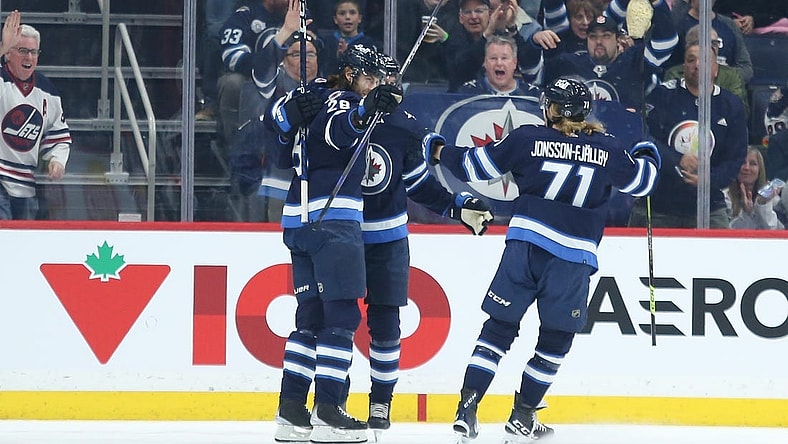 Dec 20, 2022; Winnipeg, Manitoba, CAN; Winnipeg Jets forward Kevin Stenlund (28) is congratulated by his team mates on his goal against the Ottawa Senators during the first period at Canada Life Centre. Mandatory Credit: Terrence Lee-USA TODAY Sports