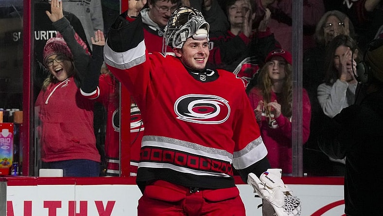 Dec 20, 2022; Raleigh, North Carolina, USA;  Carolina Hurricanes goaltender Pyotr Kochetkov (52) celebrates their victory after the game against the New Jersey Devils at PNC Arena. Mandatory Credit: James Guillory-USA TODAY Sports