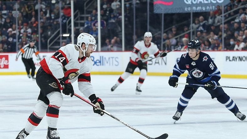 Dec 20, 2022; Winnipeg, Manitoba, CAN; Ottawa Senators forward Tyler Motte (14) skates away from Winnipeg Jets forward Cole Perfetti (91) during the first period at Canada Life Centre. Mandatory Credit: Terrence Lee-USA TODAY Sports