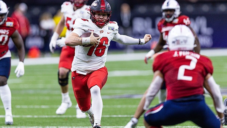 Dec 21, 2022; New Orleans, Louisiana, USA;  Western Kentucky Hilltoppers quarterback Austin Reed (16) scrambles out the pocket against the South Alabama Jaguars during the first half at Caesars Superdome. Mandatory Credit: Stephen Lew-USA TODAY Sports
