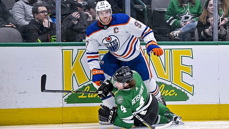 Dec 21, 2022; Dallas, Texas, USA; Edmonton Oilers center Connor McDavid (97) checks Dallas Stars defenseman Miro Heiskanen (4) during the first period at the American Airlines Center. Mandatory Credit: Jerome Miron-USA TODAY Sports