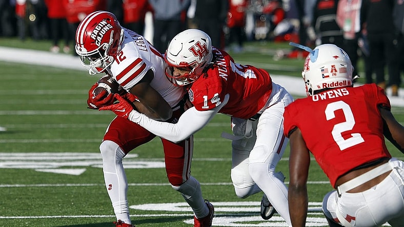 Dec 23, 2022; Shreveport, Louisiana, USA; Louisiana-Lafayette Ragin' Cajuns wide receiver Lance Legendre (12) runs after a catch as Houston Cougars linebacker Mannie Nunnery (14) makes the tackle during the first half in the 2022 Independence Bowl at Independence Stadium. Mandatory Credit: Petre Thomas-USA TODAY Sports