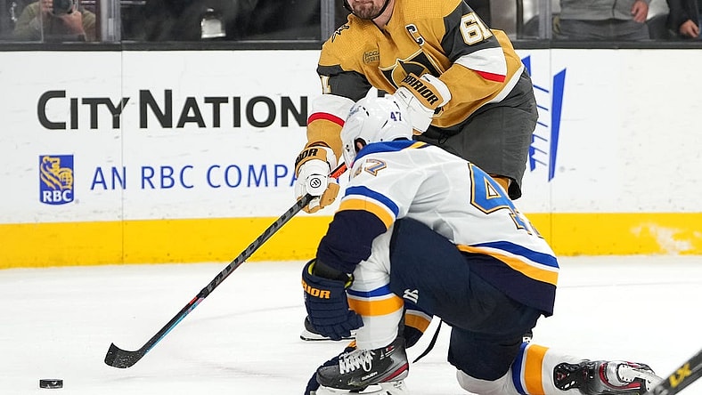 Dec 23, 2022; Las Vegas, Nevada, USA; Vegas Golden Knights right wing Mark Stone (61) sends a pass ahead of St. Louis Blues defenseman Torey Krug (47) during an overtime period at T-Mobile Arena. Mandatory Credit: Stephen R. Sylvanie-USA TODAY Sports