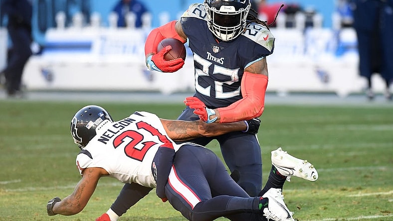 Dec 24, 2022; Nashville, Tennessee, USA; Tennessee Titans running back Derrick Henry (22) fights off a tackle attempt from Houston Texans cornerback Steven Nelson (21) during the second half at Nissan Stadium. Mandatory Credit: Christopher Hanewinckel-USA TODAY Sports