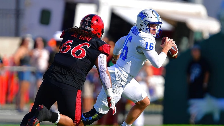 Dec 24, 2022; Honolulu, HI, USA; San Diego State Aztecs defensive lineman Jonah Tavai (66) chases down Middle Tennessee Blue Raiders quarterback Chase Cunningham (16) for a sack during the first quarter at Ching Complex. Mandatory Credit: Steven Erler-USA TODAY Sports