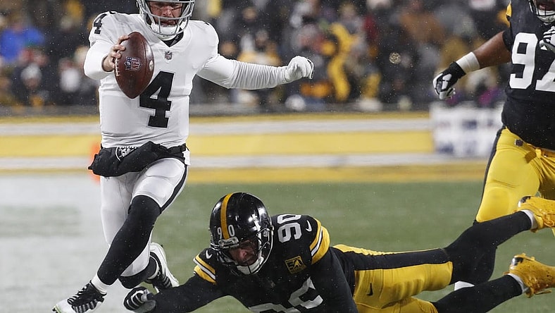 Dec 24, 2022; Pittsburgh, Pennsylvania, USA;  Las Vegas Raiders quarterback Derek Carr (4) runs the ball as Pittsburgh Steelers linebacker T.J. Watt (90) defends during the first quarter at Acrisure Stadium. Mandatory Credit: Charles LeClaire-USA TODAY Sports