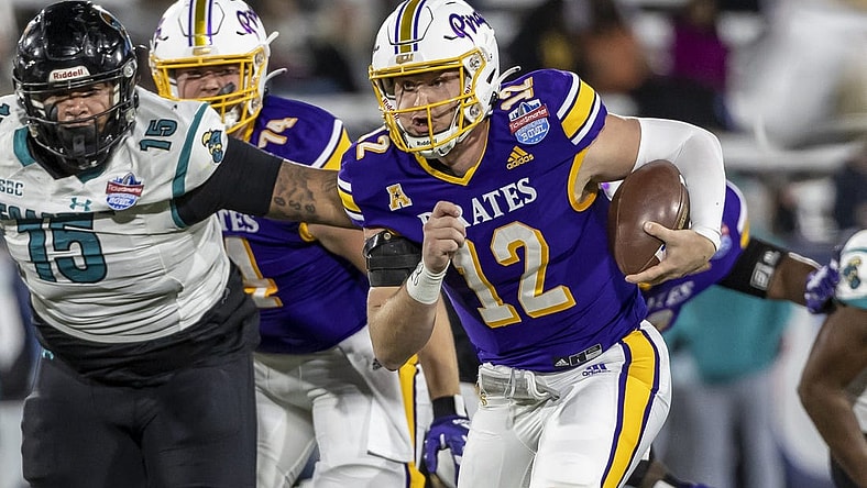 Dec 27, 2022; Birmingham, Alabama, USA; East Carolina Pirates quarterback Holton Ahlers (12) runs the ball against the Coastal Carolina Chanticleers in the 2022 Birmingham Bowl at Protective Stadium. Mandatory Credit: Vasha Hunt-USA TODAY Sports