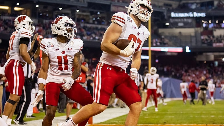 Dec 27, 2022; Phoenix, Arizona, USA; Wisconsin Badgers tight end Hayden Rucci (87) celebrates a touchdown with wide receiver Skyler Bell (11) against the Oklahoma State Cowboys in the first half of the 2022 Guaranteed Rate Bowl at Chase Field. Mandatory Credit: Mark J. Rebilas-USA TODAY Sports