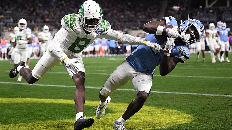 Dec 28, 2022; San Diego, CA, USA; North Carolina Tar Heels wide receiver Andre Greene Jr. (1) catches a touchdown pass while defended by Oregon Ducks defensive back Dontae Manning (8) during the first quarter of the 2022 Holiday Bowl at Petco Park. Mandatory Credit: Orlando Ramirez-USA TODAY Sports
