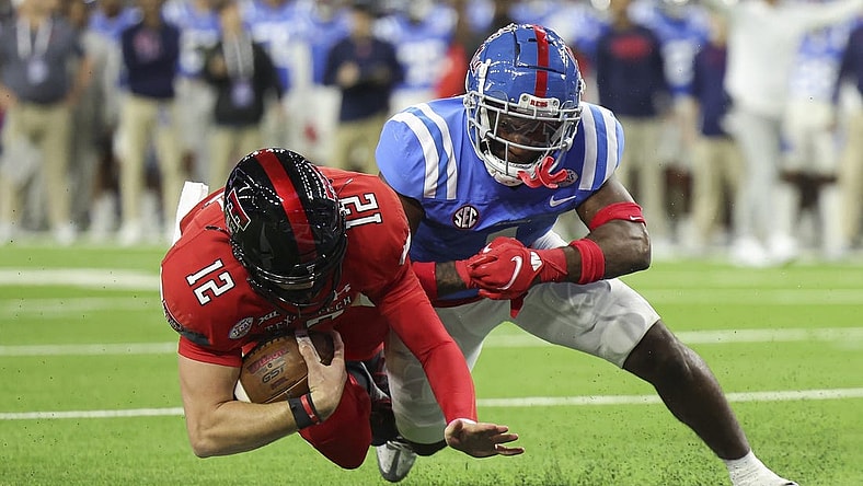 Dec 28, 2022; Houston, Texas, USA; Texas Tech Red Raiders quarterback Tyler Shough (12) falls into the end zone for a touchdown as Mississippi Rebels safety Isheem Young (1) /defends during the first quarter in the 2022 Texas Bowl at NRG Stadium. Mandatory Credit: Troy Taormina-USA TODAY Sports