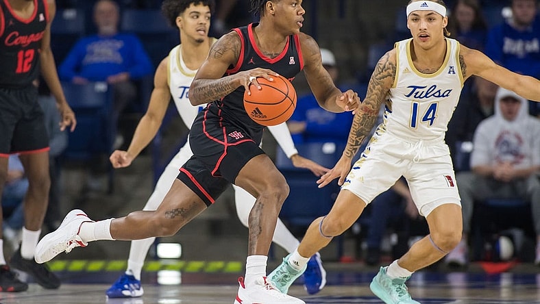Dec 28, 2022; Tulsa, Oklahoma, USA;  Houston Cougars guard Marcus Sasser (0) dribbles past Tulsa Golden Hurricane guard Anthony Pritchard (14) during the first half at Reynolds Center. Mandatory Credit: Brett Rojo-USA TODAY Sports