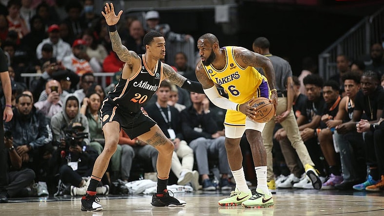 Dec 30, 2022; Atlanta, Georgia, USA; Atlanta Hawks forward John Collins (20) defends Los Angeles Lakers forward LeBron James (6) in the second quarter at State Farm Arena. Mandatory Credit: Brett Davis-USA TODAY Sports
