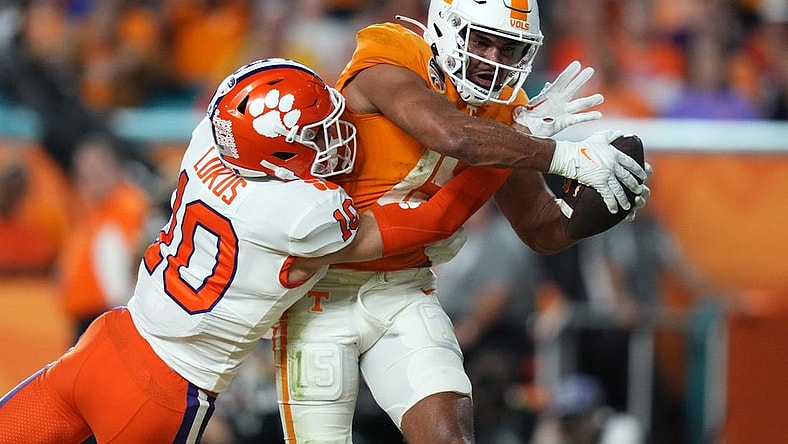 Dec 30, 2022; Miami Gardens, FL, USA; Tennessee Volunteers wide receiver Bru McCoy (15) scores a touchdown past Clemson Tigers cornerback Jeadyn Lukus (10) during the first half of the 2022 Orange Bowl at Hard Rock Stadium. Mandatory Credit: Jasen Vinlove-USA TODAY Sports