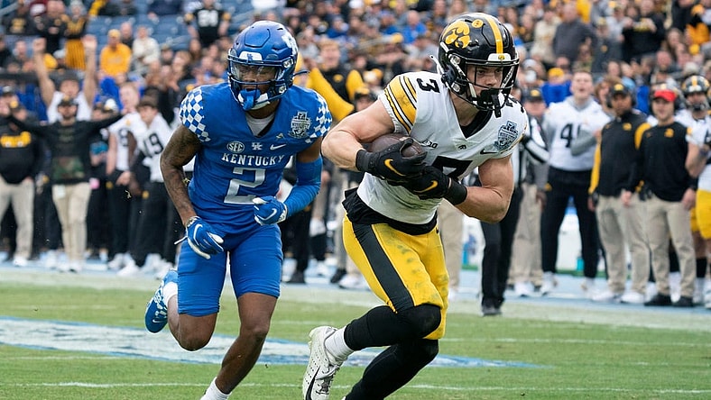 Iowa defensive back Cooper DeJean (3) pulls in an interception for a touchdown over Kentucky wide receiver Barion Brown (2) during the second quarter of the TransPerfect Music City Bowl at Nissan Stadium Saturday, Dec. 31, 2022, in Nashville, Tenn.

Ncaa Football Music City Bowl Iowa At Kentucky