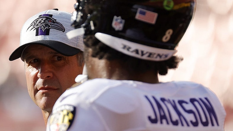 Aug 28, 2021; Landover, Maryland, USA; Baltimore Ravens head coach John Harbaugh (L) talks with Ravens quarterback Lamar Jackson (8) during warmups prior to their game against the Washington Football Team at FedExField. Mandatory Credit: Geoff Burke-USA TODAY Sports