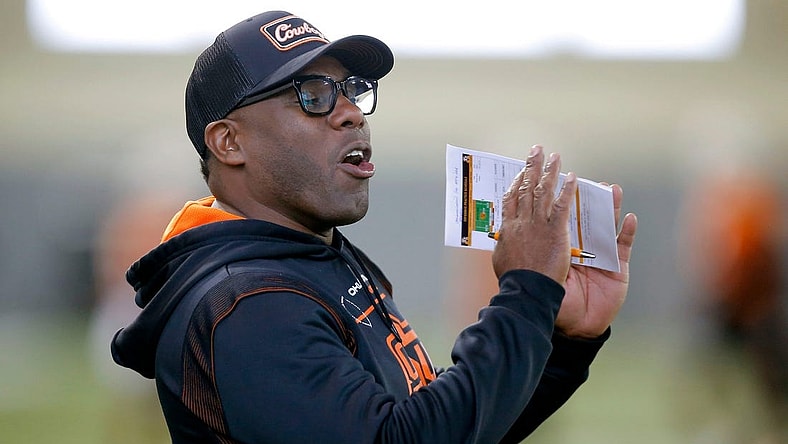 OSU defensive coordinator Derek Mason shouts instructions to his players on March 22.

cover small