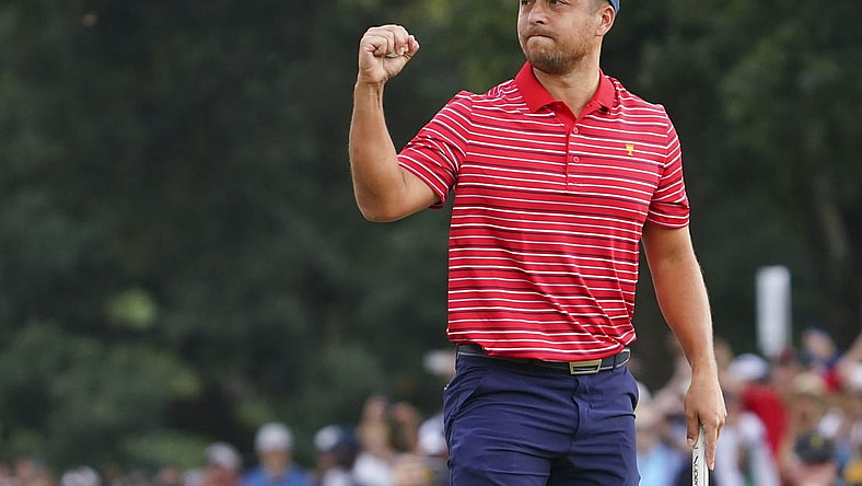 Sep 25, 2022; Charlotte, North Carolina, USA; Team USA golfer Xander Schauffele celebrates clinching the win for Team USA on the 18th green during the singles match play of the Presidents Cup golf tournament at Quail Hollow Club. Mandatory Credit: Peter Casey-USA TODAY Sports