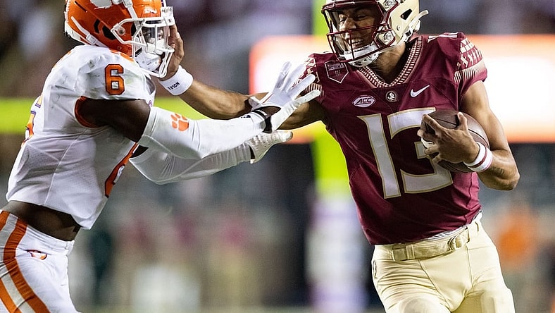 Florida State Seminoles quarterback Jordan Travis (13) stiff arms Clemson Tigers cornerback Sheridan Jones (6). The Clemson Tigers defeated the Florida State Seminoles 34-28 at Doak Campbell Stadium on Saturday, Oct. 15, 2022.

Fsu V Clemson First534