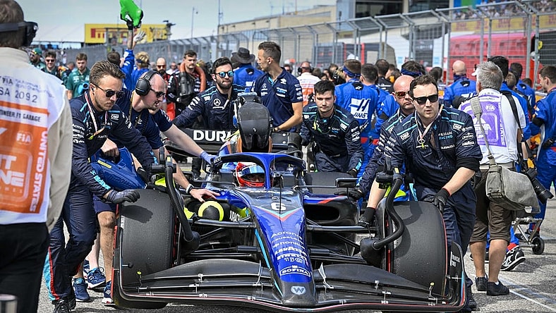 Oct 23, 2022; Austin, Texas, USA; The crew of Williams Racing driver Nicholas Latifi (6) of Team Canada wheel their car onto the grid before the start of the U.S. Grand Prix F1 race at Circuit of the Americas. Mandatory Credit: Jerome Miron-USA TODAY Sports