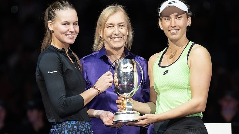 Nov 7, 2022; Forth Worth, TX, USA; Martina Navratilova, Elise Mertens (BEL) and Veronika Kudermetova pose with the trophy after winning the doubles final against Barbora Krejcikova (CZE) and Katerina Siniakova (CZE) on day eight of the WTA Finals at Dickies Arena.