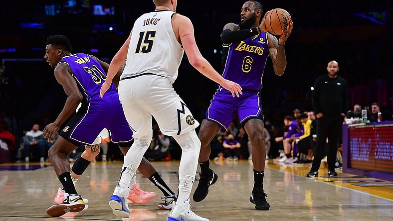 Dec 16, 2022; Los Angeles, California, USA; Los Angeles Lakers forward LeBron James (6) controls the ball against Denver Nuggets center Nikola Jokic (15) during the second half at Crypto.com Arena. Mandatory Credit: Gary A. Vasquez-USA TODAY Sports