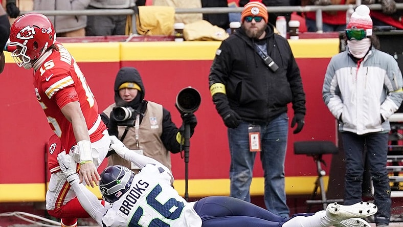 Dec 24, 2022; Kansas City, Missouri, USA; Kansas City Chiefs quarterback Patrick Mahomes (15) scores a touchdown as Seattle Seahawks linebacker Jordyn Brooks (56) makes the tackle during the second half at GEHA Field at Arrowhead Stadium. Mandatory Credit: Denny Medley-USA TODAY Sports