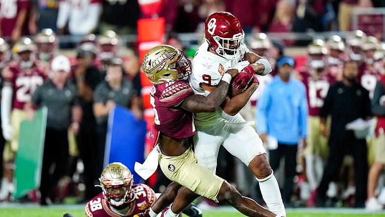 Dec 29, 2022; Orlando, Florida, USA; Florida State Seminoles defensive back Jammie Robinson (10) tackles Oklahoma Sooners tight end Brayden Willis (9) during the second half in the 2022 Cheez-It Bowl at Camping World Stadium. Mandatory Credit: Rich Storry-USA TODAY Sports
