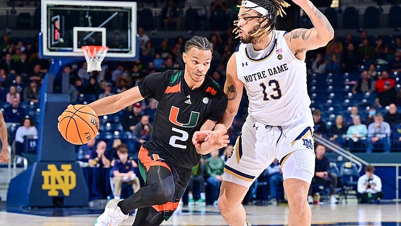 Dec 30, 2022; South Bend, Indiana, USA; Miami Hurricanes guard Isaiah Wong (2) dribbles as Notre Dame Fighting Irish forward Dom Campbell (13) defends in the second half at the Purcell Pavilion. Mandatory Credit: Matt Cashore-USA TODAY Sports