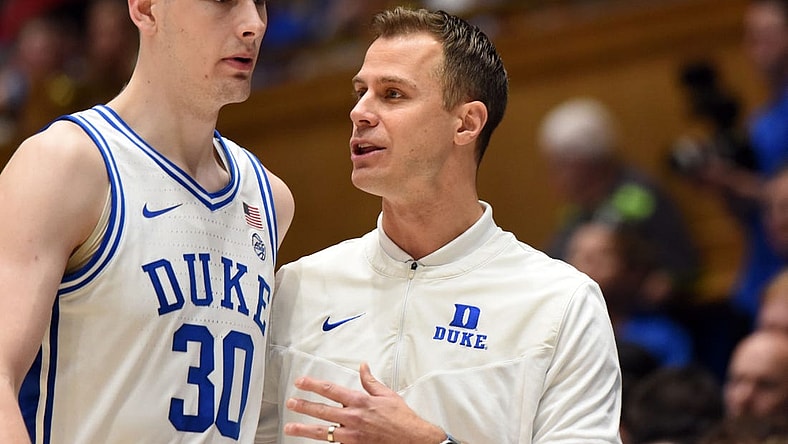 Dec 31, 2022; Durham, North Carolina, USA; Duke Blue Devils head coach Jon Scheyer (right) talks to center Kyle Filipowski (30) during the second half against the Florida State Seminoles at Cameron Indoor Stadium. The Blue Devils won 86-67.  Mandatory Credit: Rob Kinnan-USA TODAY Sports