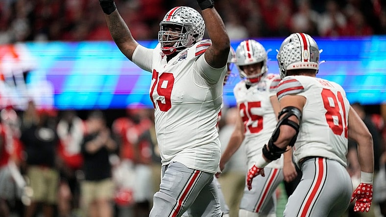 Dec 31, 2022; Atlanta, Georgia, USA; Ohio State Buckeyes offensive lineman Dawand Jones (79) celebrates a touchdown by wide receiver Marvin Harrison Jr. (18) during the first half of the Peach Bowl in the College Football Playoff semifinal at Mercedes-Benz Stadium. Mandatory Credit: Adam Cairns-The Columbus Dispatch

Ncaa Football Peach Bowl Ohio State At Georgia