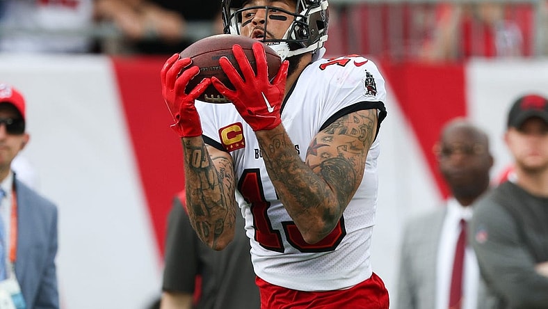Jan 1, 2023; Tampa, Florida, USA;  Tampa Bay Buccaneers wide receiver Mike Evans (13) catches a pass from touchdown against the Carolina Panthers in the second quarter at Raymond James Stadium. Mandatory Credit: Nathan Ray Seebeck-USA TODAY Sports